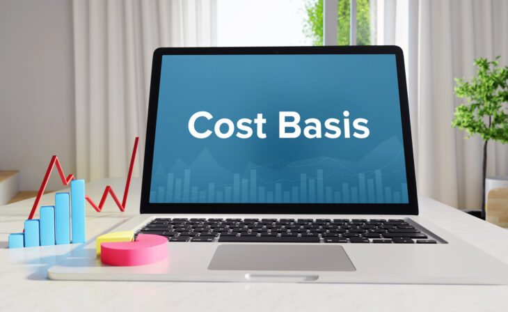 Cost Basis – Statistics/Business. Laptop in the office with term on the display. Finance/Economics.